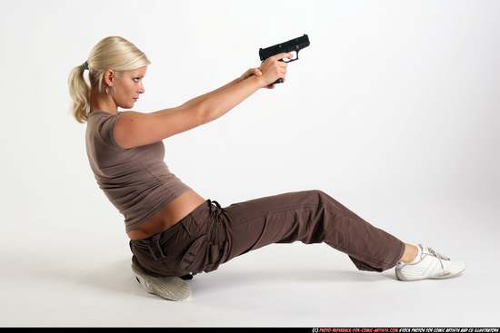 Woman Adult Athletic White Fighting with gun Kneeling poses Sportswear