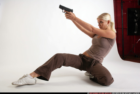 Woman Adult Athletic White Fighting with gun Kneeling poses Sportswear