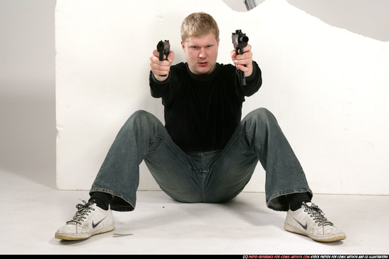 Man Young Average White Fighting with gun Sitting poses Sportswear