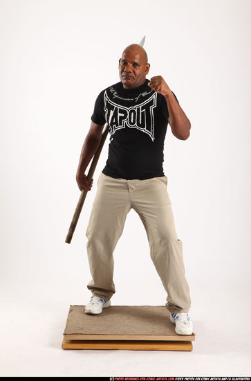 Man Old Average Black Fighting with spear Standing poses Casual