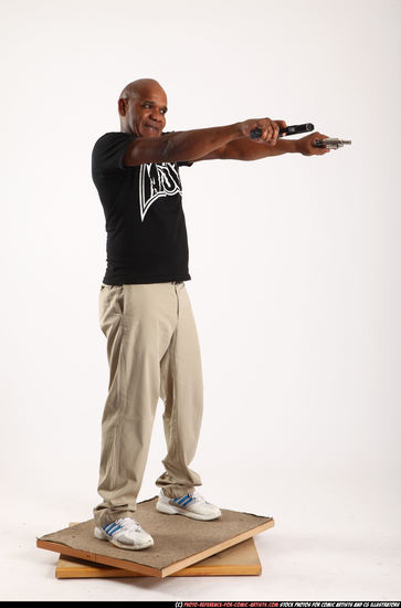 Man Old Average Black Fighting with gun Standing poses Casual