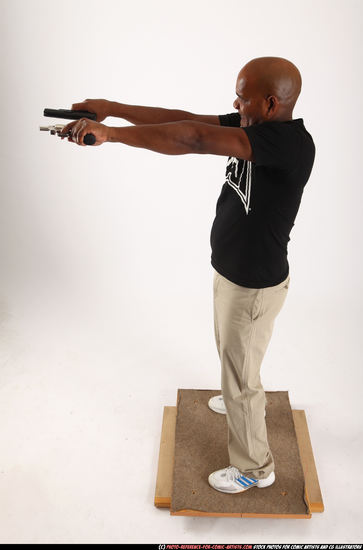 Man Old Average Black Fighting with gun Standing poses Casual