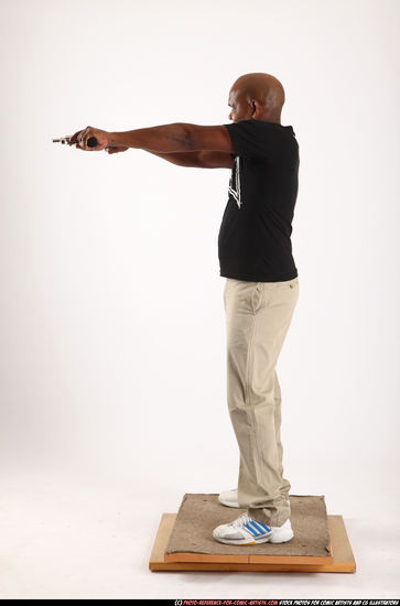 Man Old Average Black Fighting with gun Standing poses Casual