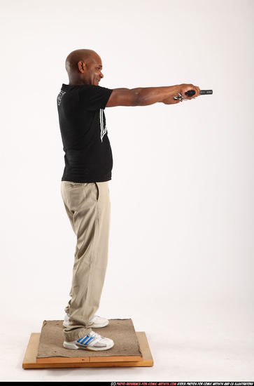 Man Old Average Black Fighting with gun Standing poses Casual