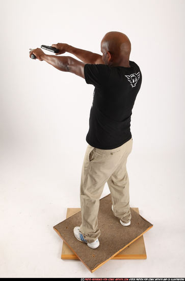 Man Old Average Black Fighting with gun Standing poses Casual