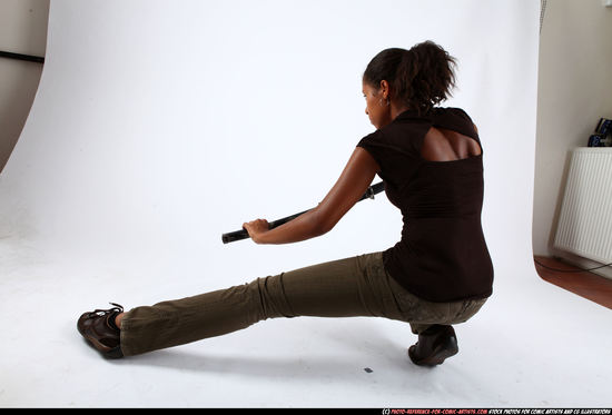 Woman Young Athletic Black Fighting with sword Kneeling poses Casual