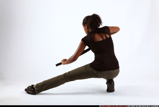 Woman Young Athletic Black Fighting with sword Kneeling poses Casual