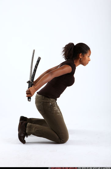 Woman Young Athletic Black Fighting with sword Kneeling poses Casual