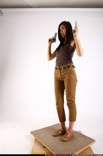 Woman Young Athletic Fighting with gun Standing poses Casual Asian