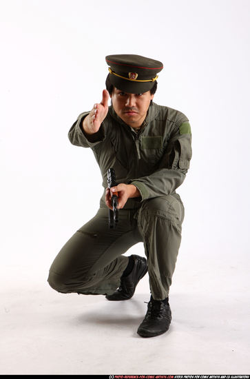 Man Adult Average Fighting with submachine gun Kneeling poses Army Asian