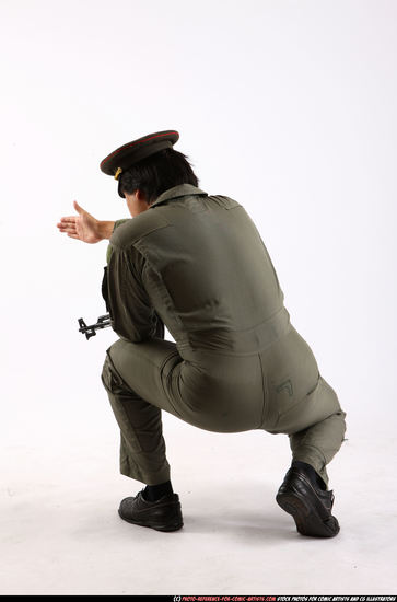 Man Adult Average Fighting with submachine gun Kneeling poses Army Asian