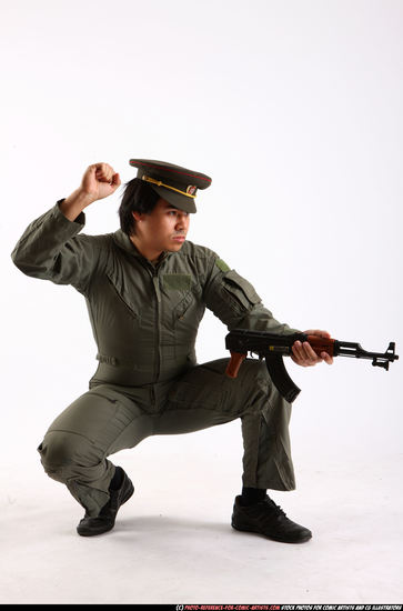 Man Adult Average Fighting with submachine gun Kneeling poses Army Asian