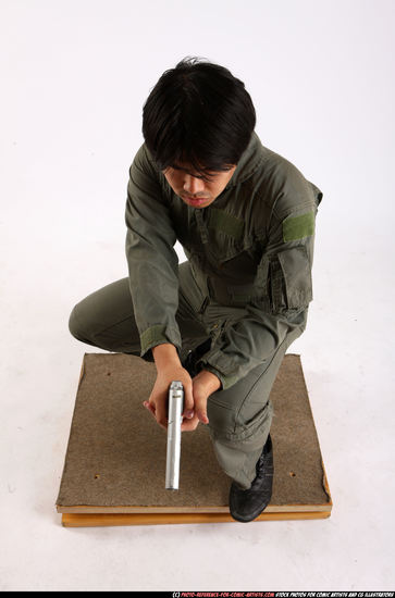 Man Adult Average Fighting with gun Kneeling poses Army Asian