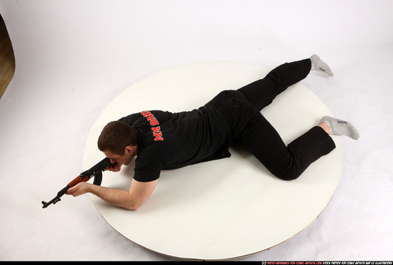 Man Adult Athletic White Fighting with submachine gun Laying poses Sportswear