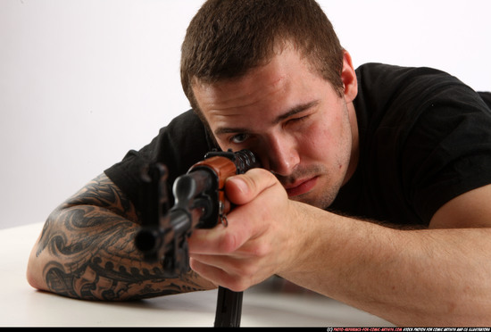 Man Adult Athletic White Fighting with submachine gun Laying poses Sportswear