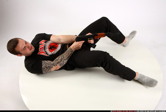 Man Adult Athletic White Fighting with submachine gun Laying poses Casual