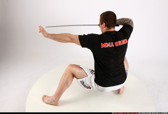 Man Adult Athletic White Fighting with sword Kneeling poses Sportswear