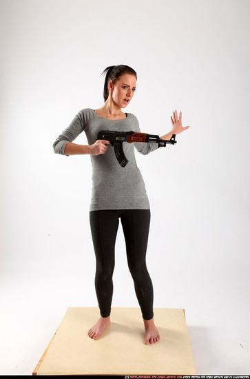 Woman Adult Athletic White Fighting with submachine gun Standing poses Casual