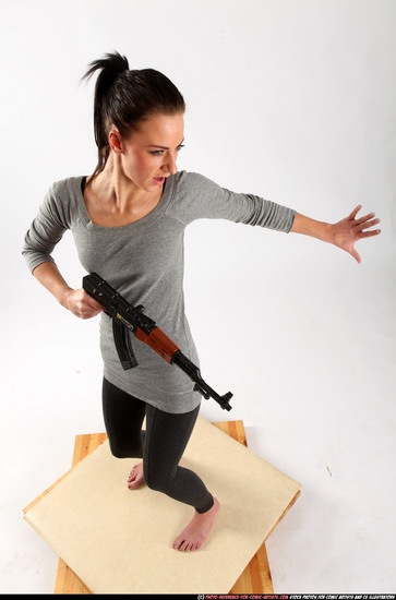 Woman Adult Athletic White Fighting with submachine gun Standing poses Casual