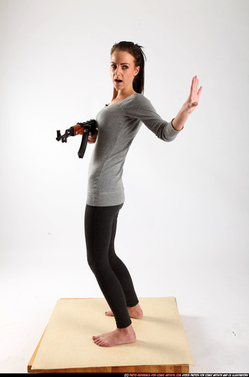 Woman Adult Athletic White Fighting with submachine gun Standing poses Casual