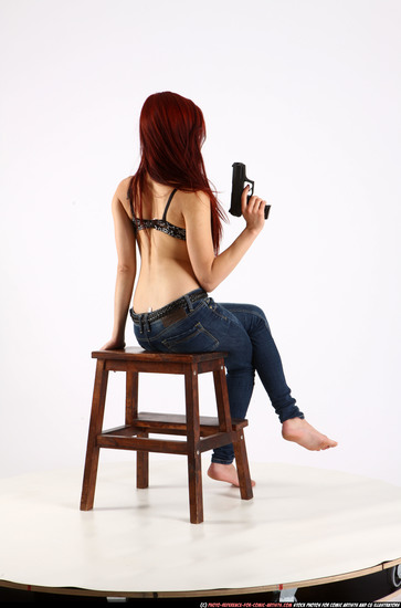 Woman Young Athletic White Fighting with gun Sitting poses Pants