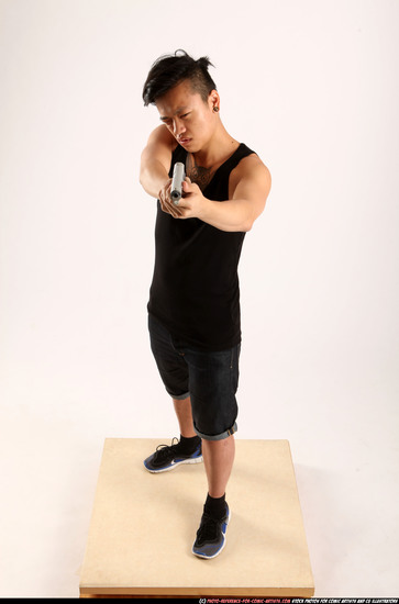 Man Young Athletic Fighting with gun Standing poses Casual Asian