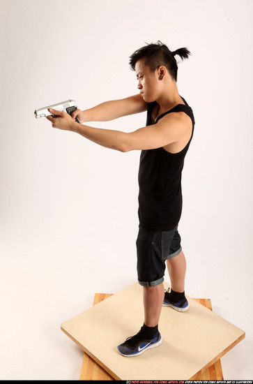 Man Young Athletic Fighting with gun Standing poses Casual Asian