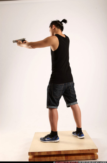 Man Young Athletic Fighting with gun Standing poses Casual Asian