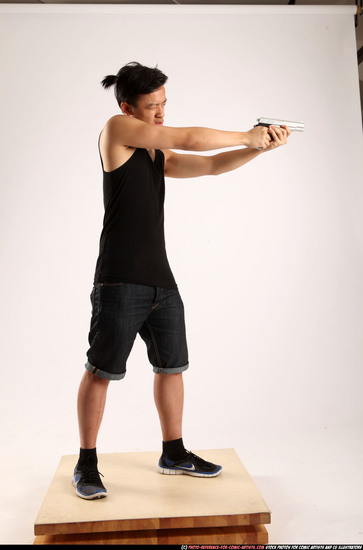 Man Young Athletic Fighting with gun Standing poses Casual Asian