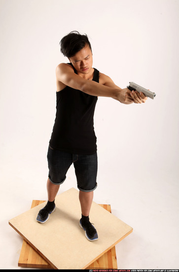 Man Young Athletic Fighting with gun Standing poses Casual Asian