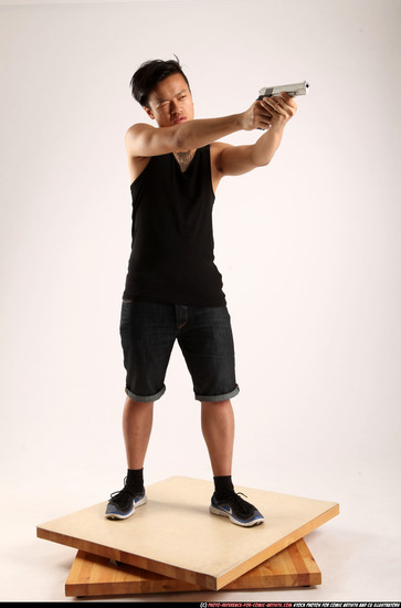 Man Young Athletic Fighting with gun Standing poses Casual Asian