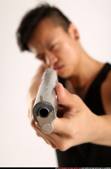 Man Young Athletic Fighting with gun Standing poses Casual Asian