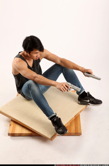 Man Young Athletic Fighting with gun Sitting poses Casual Asian