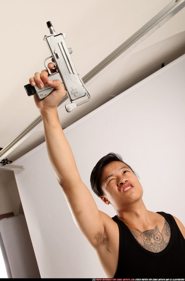 Man Young Athletic Fighting with submachine gun Standing poses Casual Asian