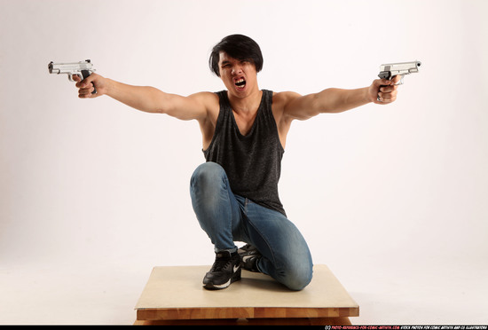 Man Young Athletic Fighting with gun Kneeling poses Casual Asian