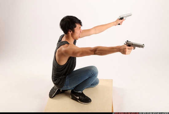 Man Young Athletic Fighting with gun Kneeling poses Casual Asian