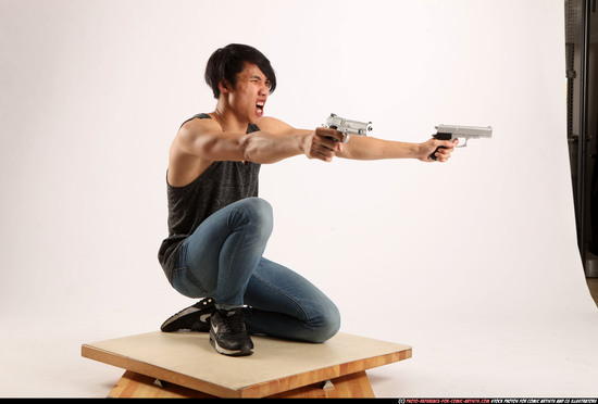 Man Young Athletic Fighting with gun Kneeling poses Casual Asian