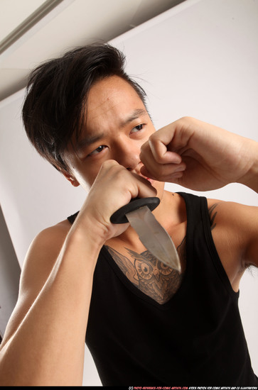 Man Young Athletic Fighting with knife Standing poses Casual Asian