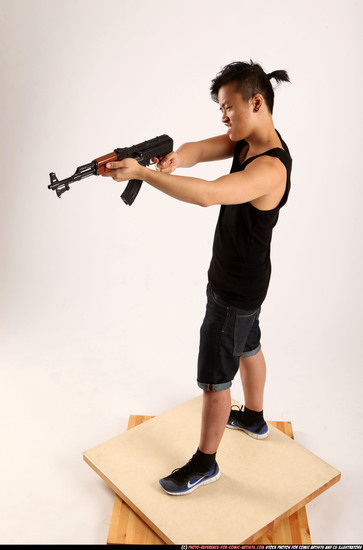 Man Young Athletic Fighting with submachine gun Standing poses Casual Asian