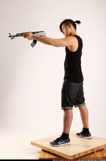 Man Young Athletic Fighting with submachine gun Standing poses Casual Asian