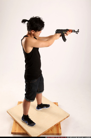 Man Young Athletic Fighting with submachine gun Standing poses Casual Asian