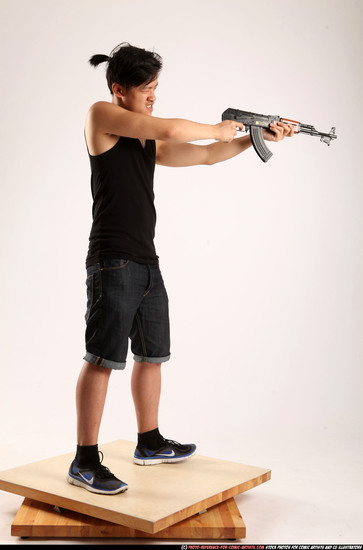 Man Young Athletic Fighting with submachine gun Standing poses Casual Asian