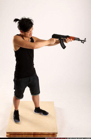 Man Young Athletic Fighting with submachine gun Standing poses Casual Asian