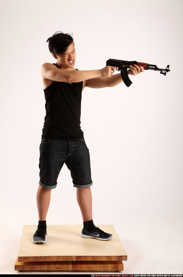 Man Young Athletic Fighting with submachine gun Standing poses Casual Asian