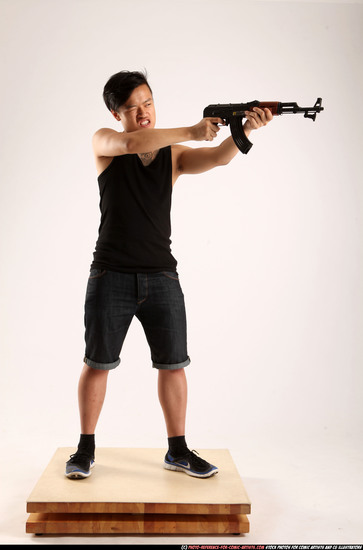 Man Young Athletic Fighting with submachine gun Standing poses Casual Asian