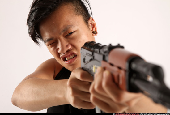 Man Young Athletic Fighting with submachine gun Standing poses Casual Asian