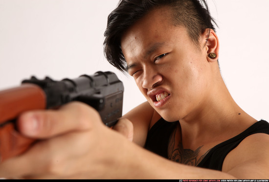 Man Young Athletic Fighting with submachine gun Standing poses Casual Asian