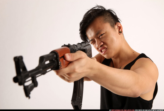 Man Young Athletic Fighting with submachine gun Standing poses Casual Asian