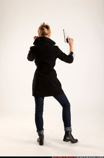 Woman Adult Athletic White Fighting with gun Standing poses Coat