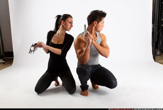 Man & Woman Adult Athletic White Fighting with gun Kneeling poses Casual